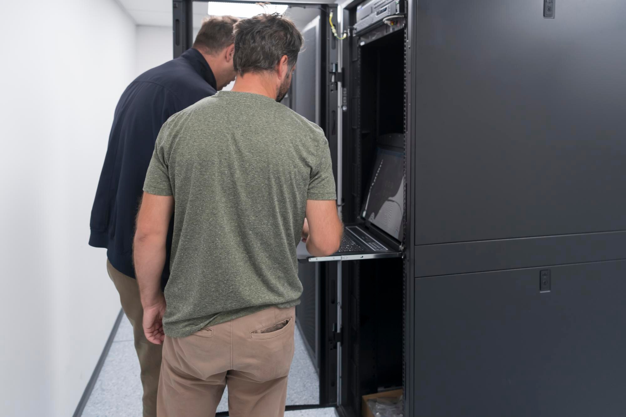 couple server engineers cooperate high tech data centers technicians team updating hardware inspecti